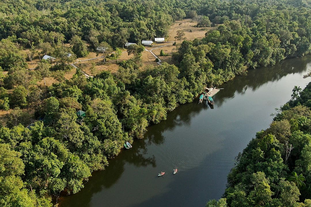 Kayakers on Prek Tachan river next to Cardamom Tented Camp in Koh Kong Province, Cambodia