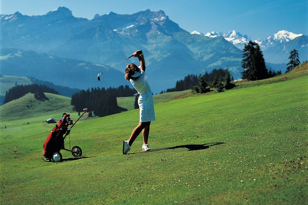 Woman golfing in Villar-sur-Ollan, Switzerland