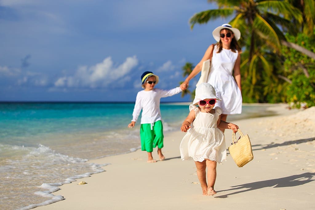 Mother with kids on the beach in Fiji