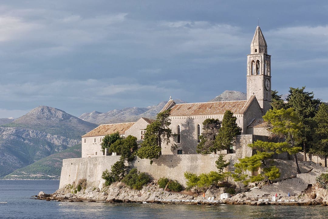 A private island featuring a 15th-century Franciscan monastery, boasting sandy beaches and a car-free environment.