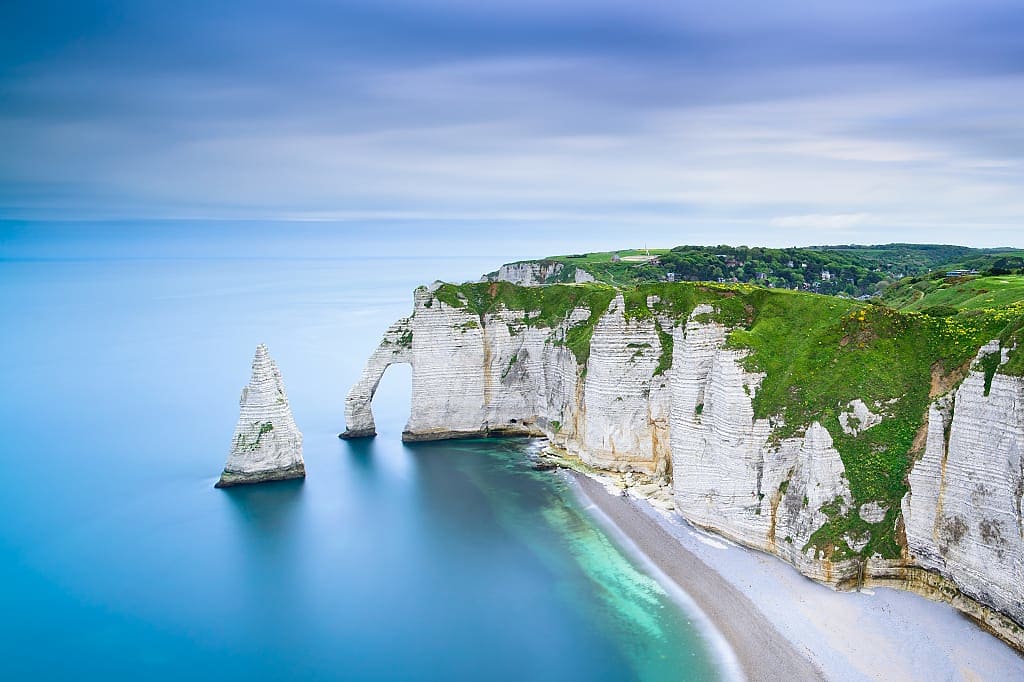 Etretat Aval cliff rocks and natural arch in Normandy, France.