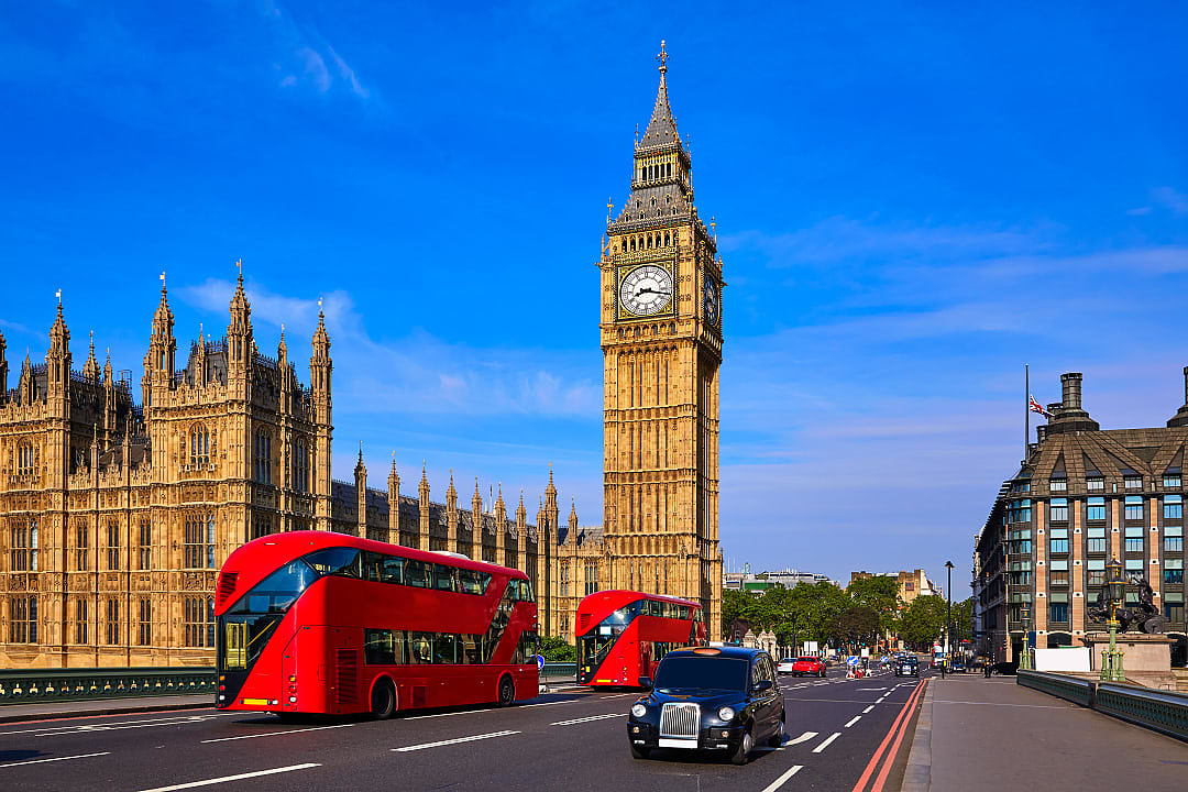 Double decker buses crossing Westminster Bridge in London, England
