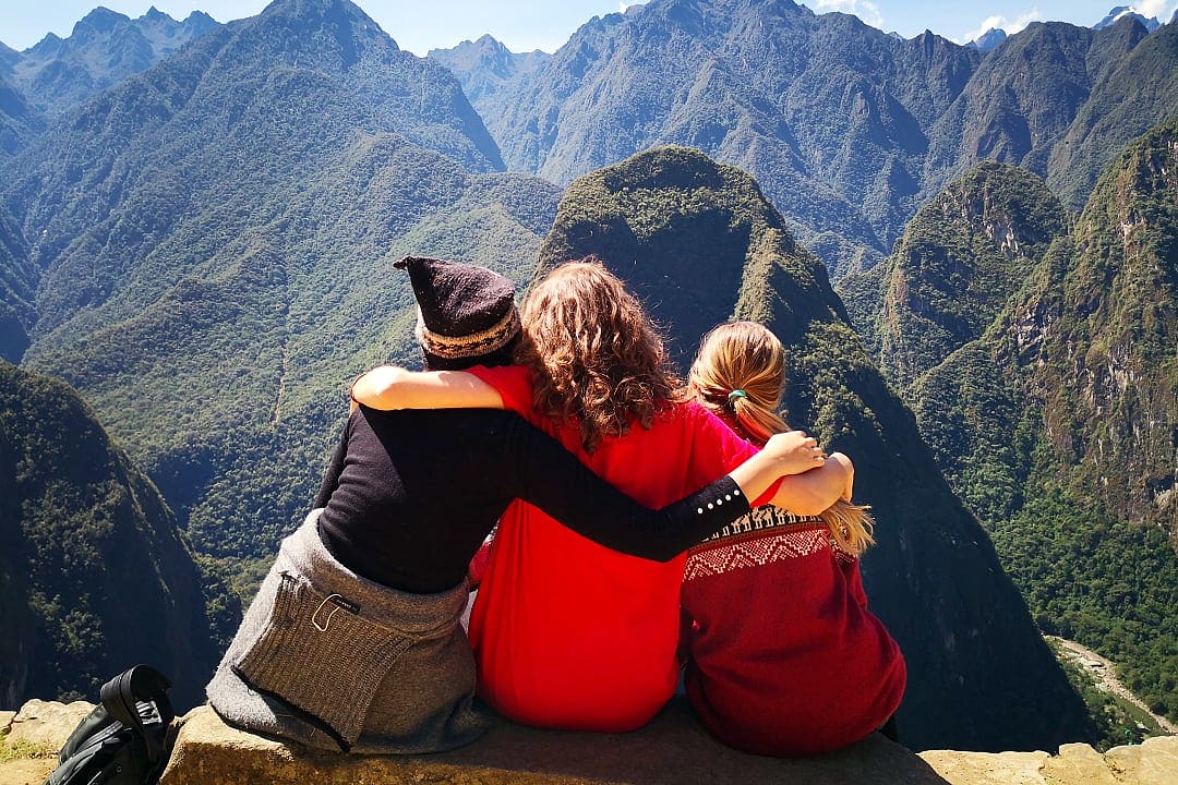 Mother and daughters on family vacation in the Andes Mountains at Machu Picchu, Peru