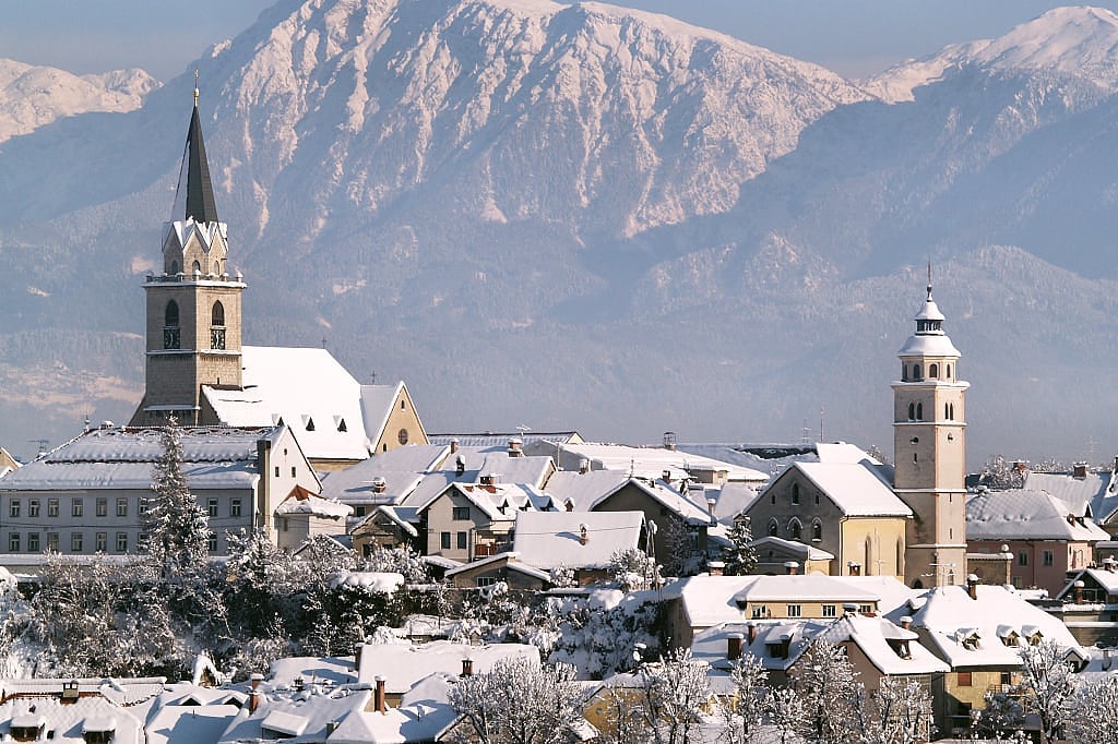 Snow covered town of Kranj with the Kamnick Alps covered in Slovenia