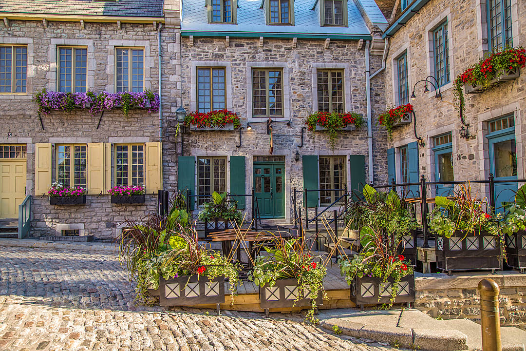 Colorful flowers decorate stone buildings in Old Quebec City.