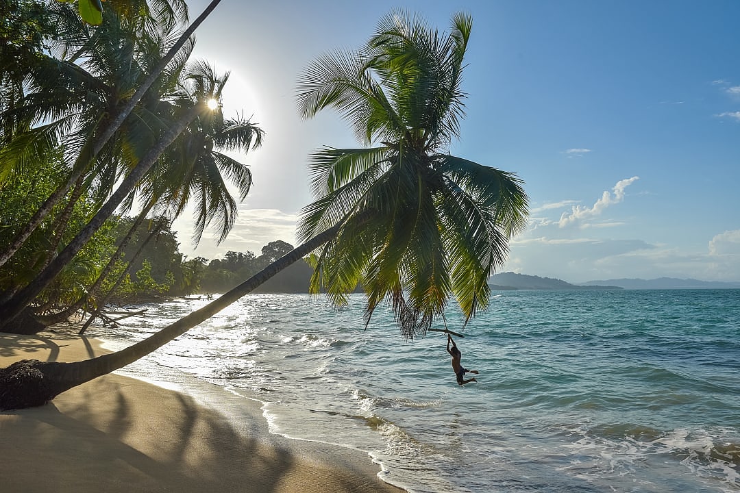 Boy playing at Punta Uva beach in Costa Rica