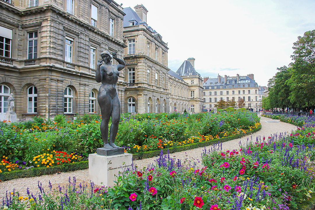 Statue and colorful flowers in the Luxembourg Garden in Paris