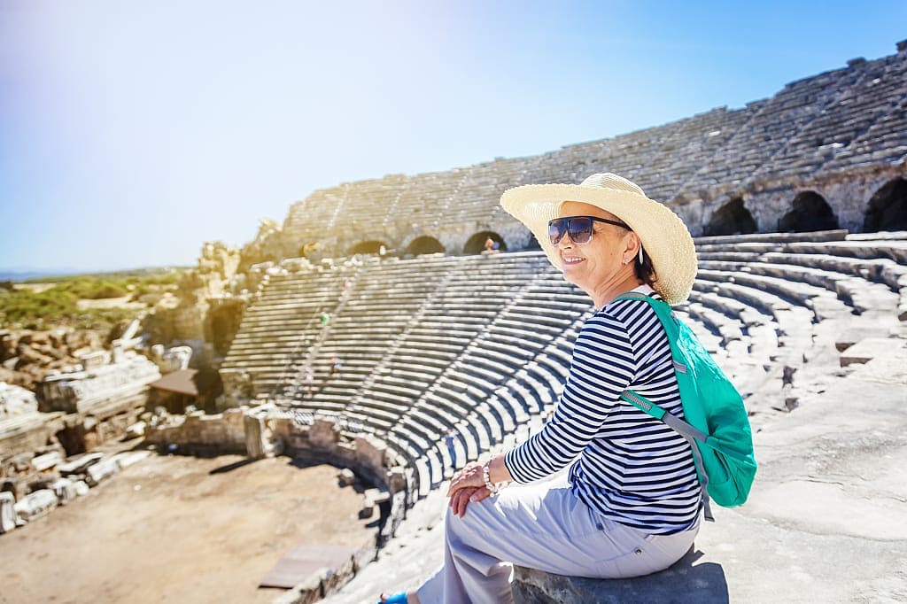 Senior woman at Greek amphitheater ruins