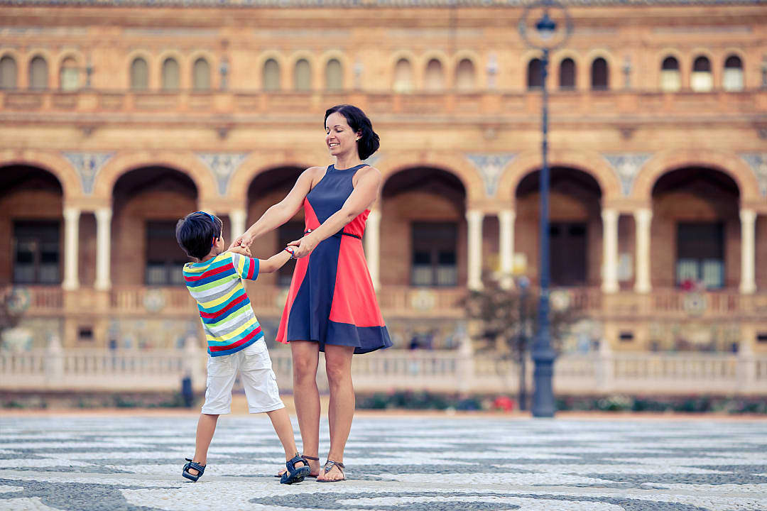 Mother and son playing at Plaza de Espana in Seville, Spain.