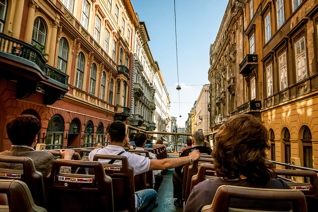 Double-decker bus through the historic buildings in Budapest, Hungary.