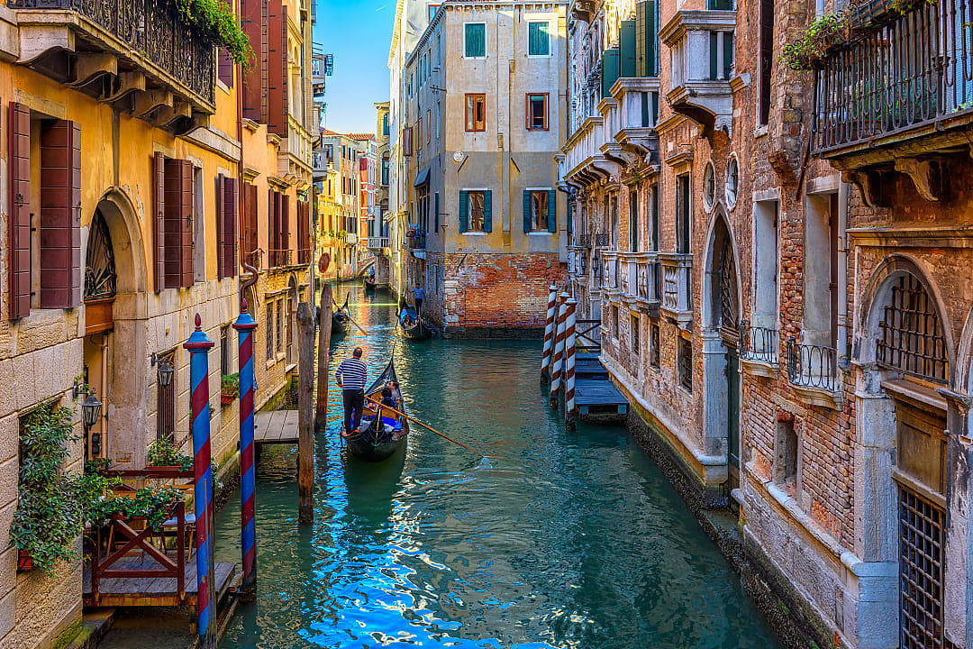 Gondolier navigating the canals in Venice, Italy