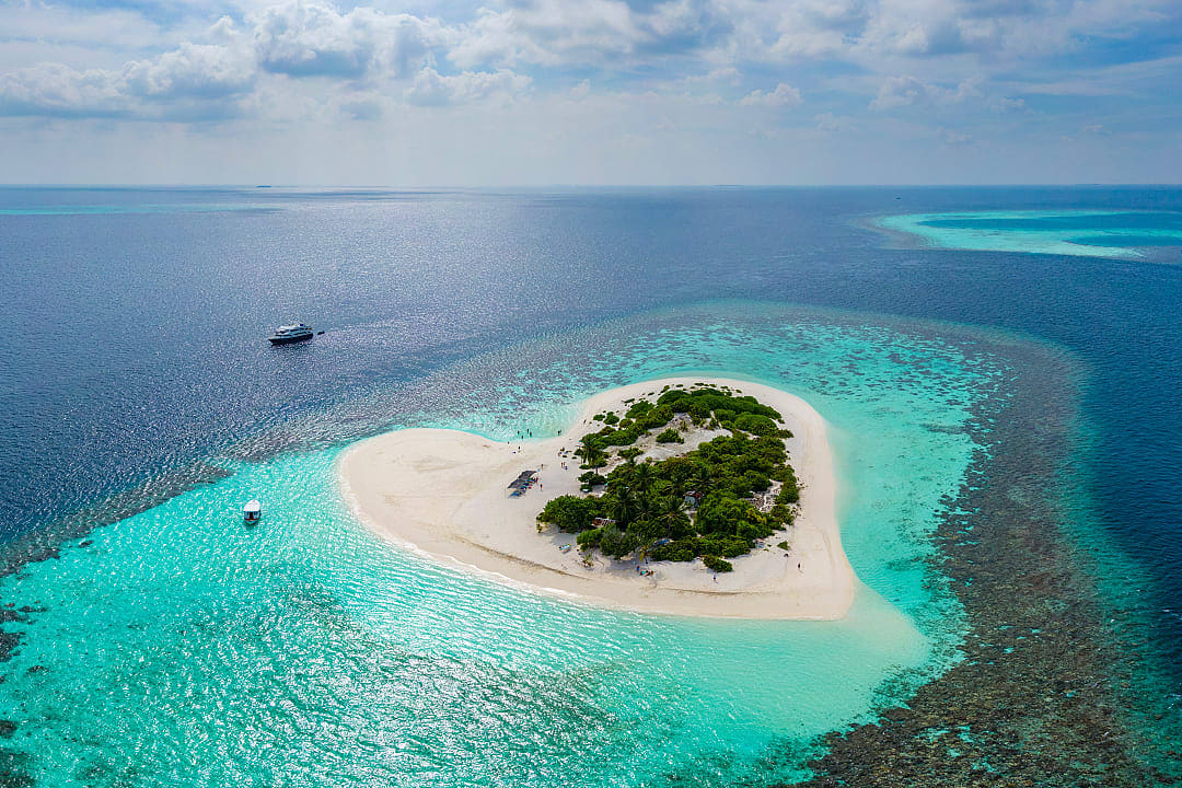 Tropical island and coral reef in the Maldives