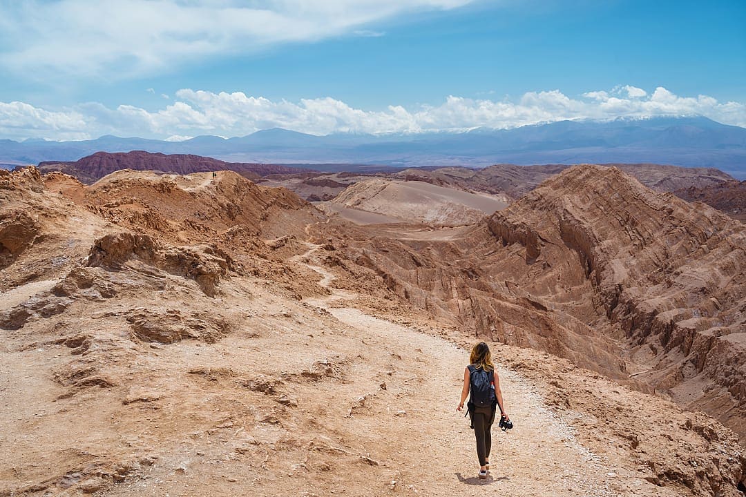 Woman hiking through Moon Valley in the Atacama Desert, Chile