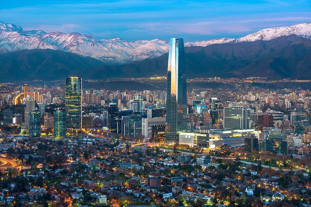 Skyline of Santiago, Chile, with modern skyscrapers and the Andes Mountains in the background at sunset