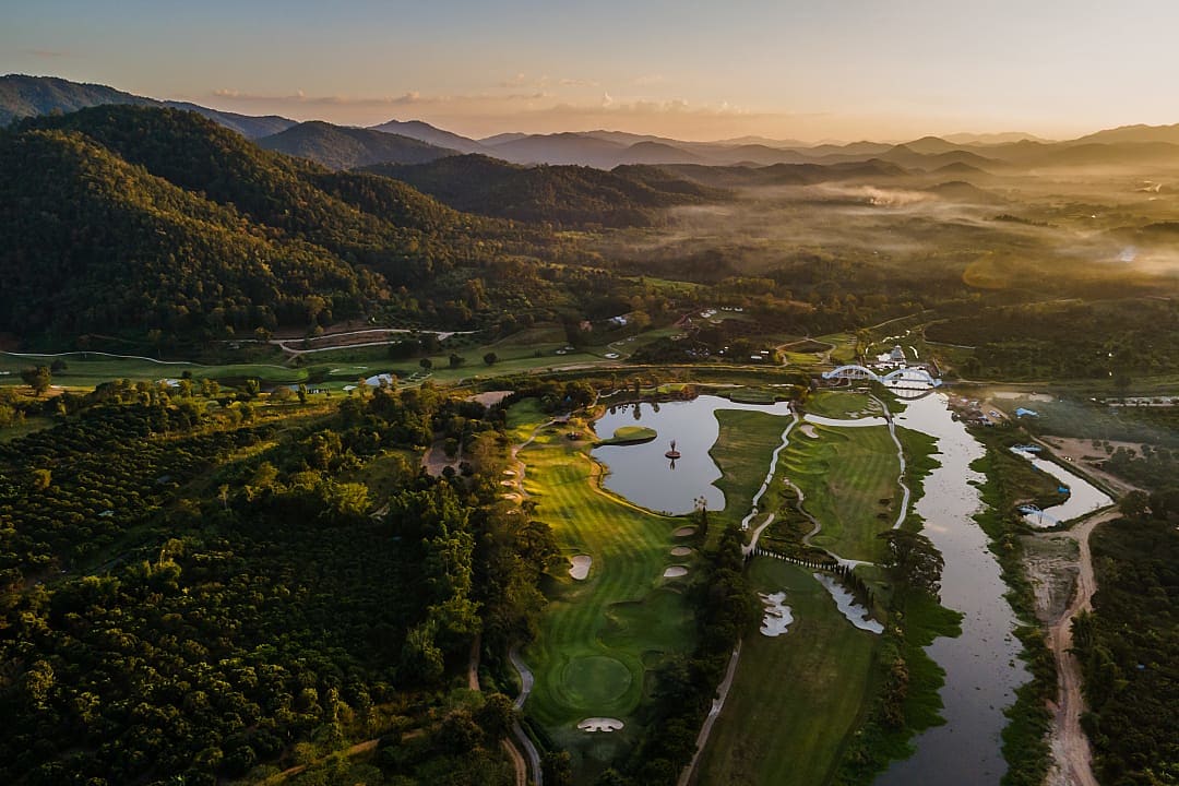 Golf course in Lamphun, Thailand surrounded by lush tropical forest