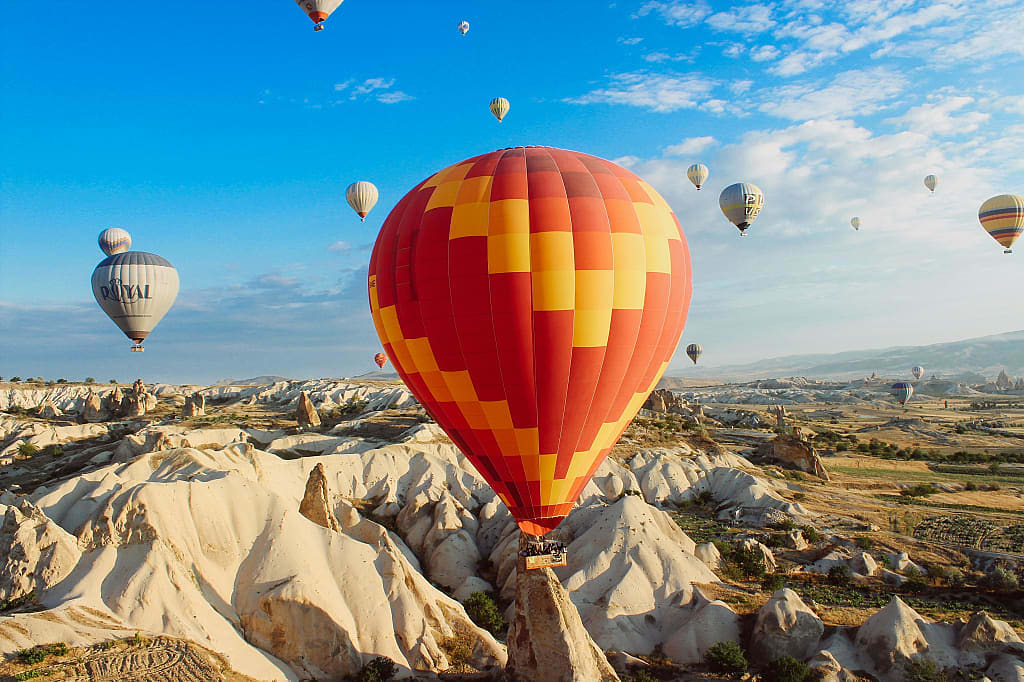 Hot air balloons over rock formations in Cappadocia, Turkey