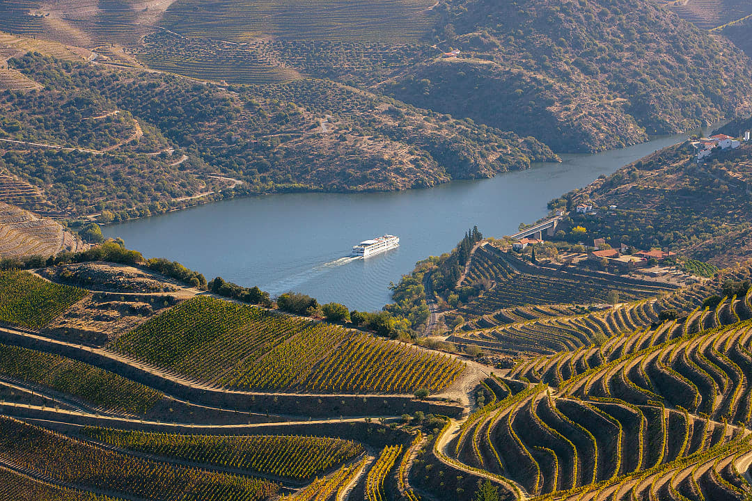 Ship on the Douro River, surrounded by the Alto Douro vineyards.
