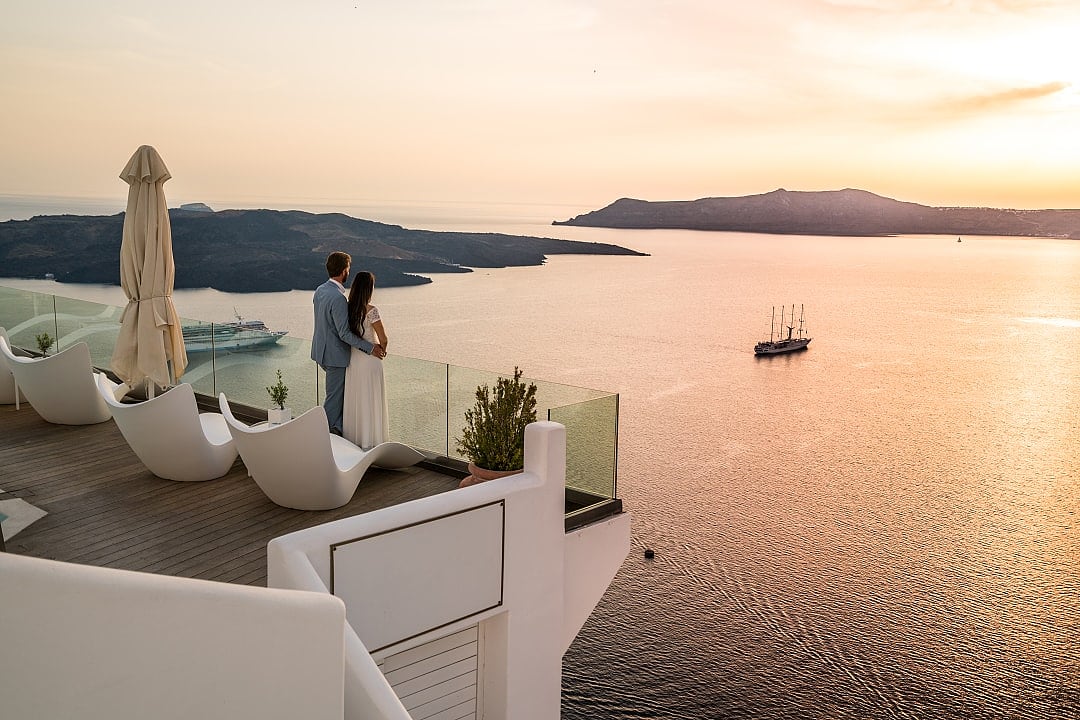 Couple watching the sunset in Santorini.