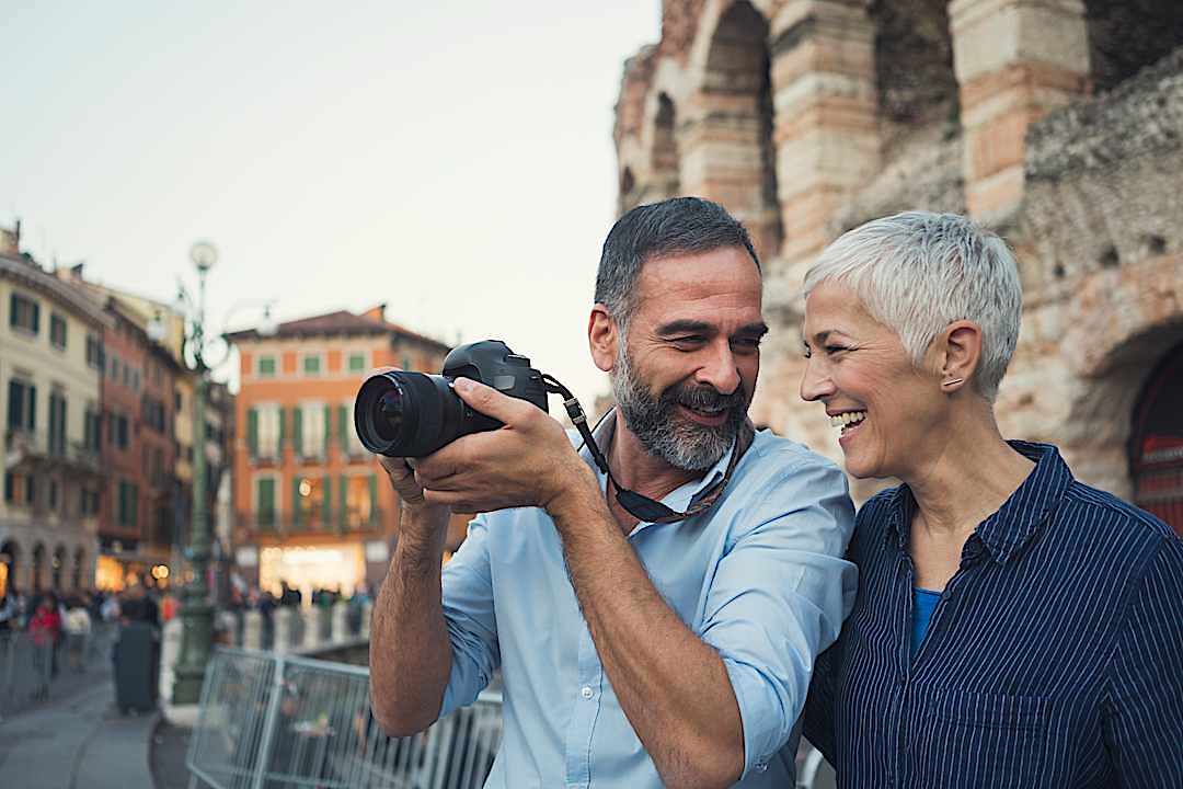 A couple taking pictures in Verona, Italy.