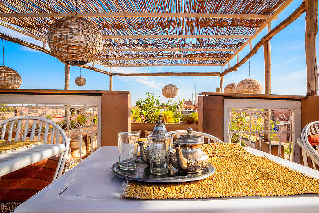 A traditional tea setting is prepared on the rooftop terrace of a riad in Marrakech.