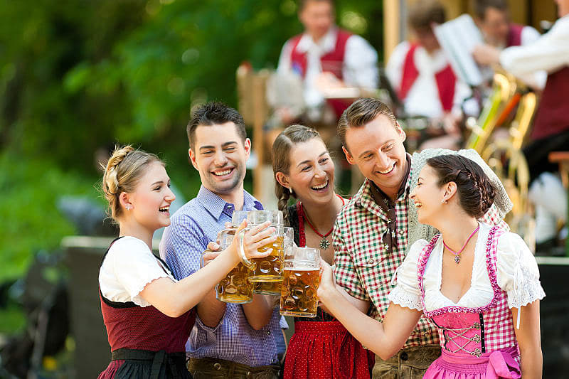 Friends toasting with beer glasses at Oktoberfest celebration