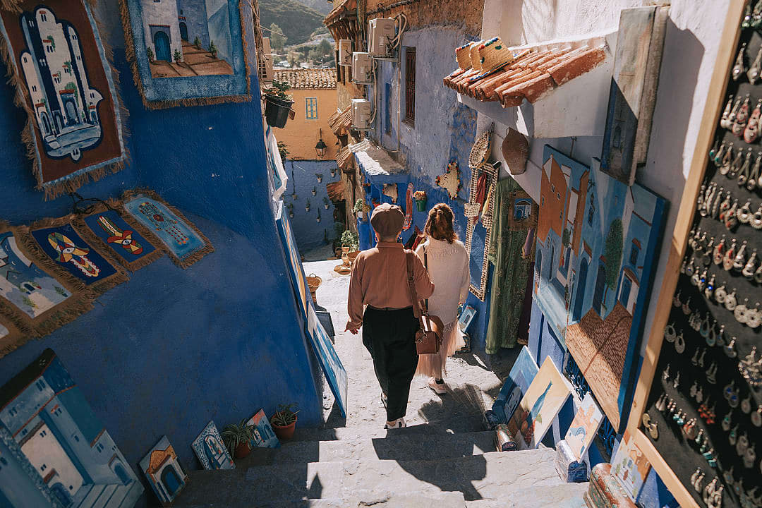 Friends shopping in the souk market of Chefchaouen, enjoying the mild winter weather.ying the mild winters weather.