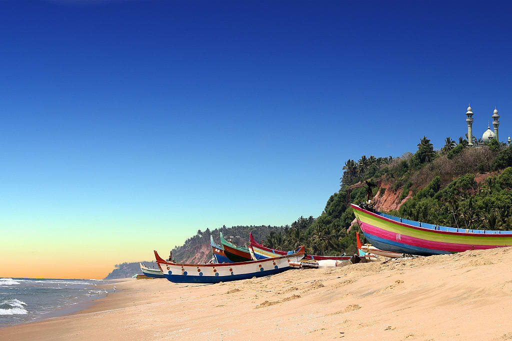 Colorful boats on the sandy beach in South Cliff Varkala, India
