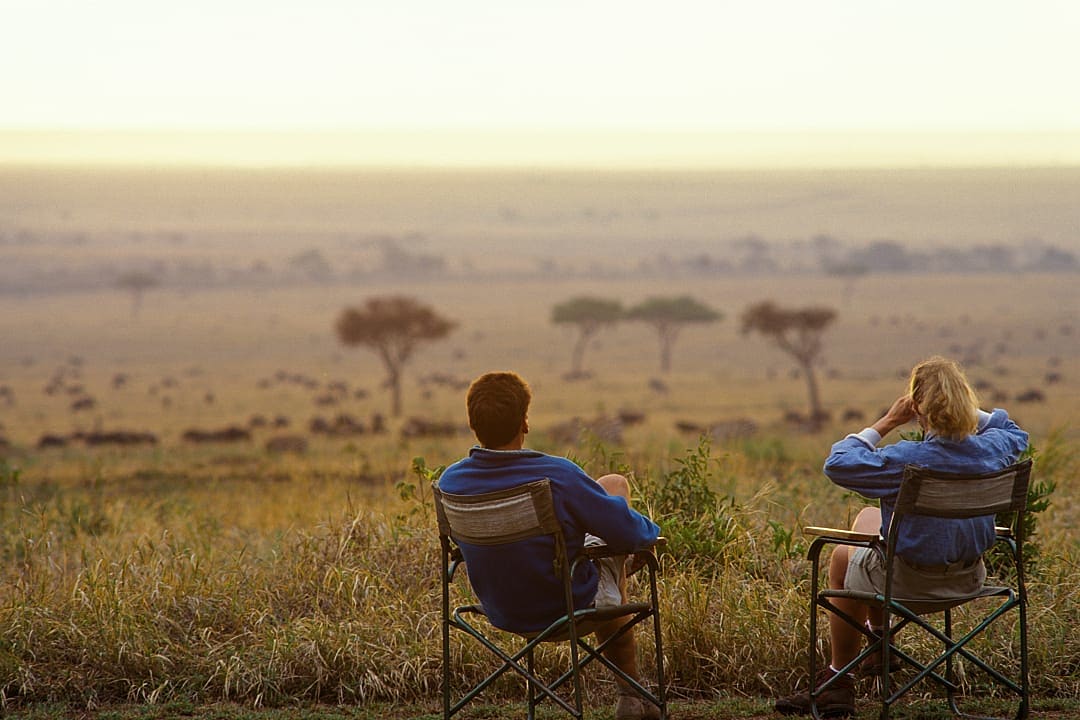 Couple on viewing wildlife on the savannah in Keyna