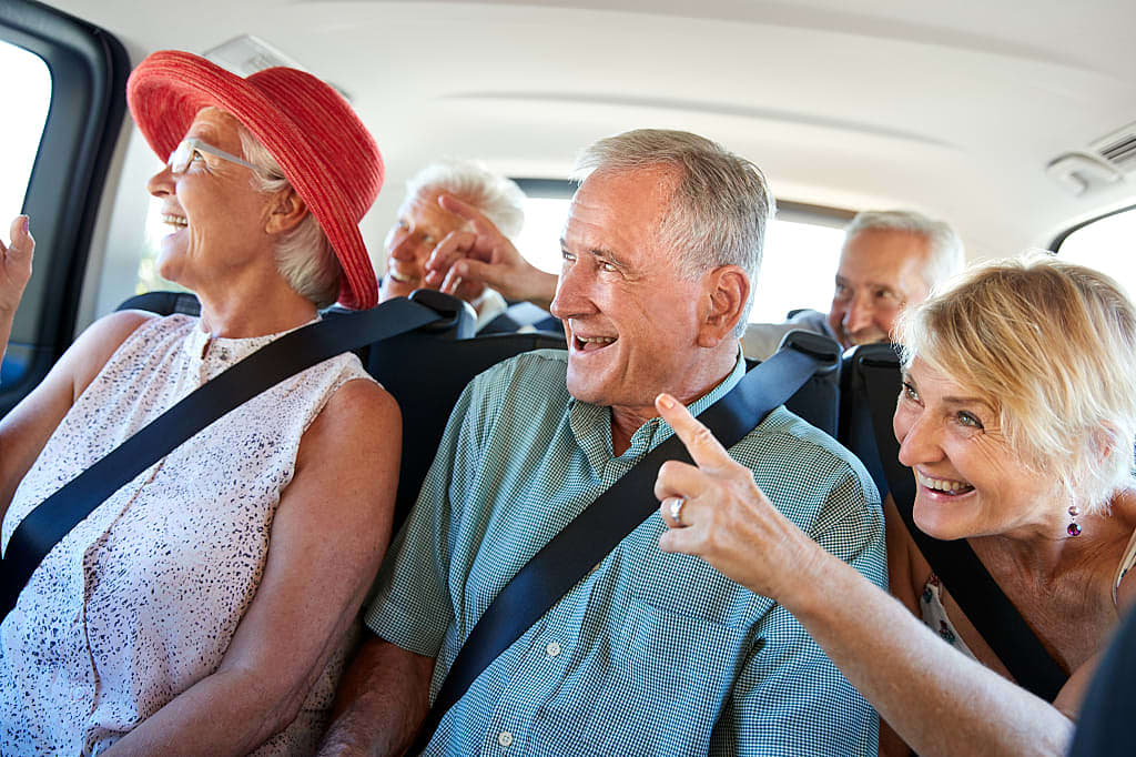 Group of senior travelers being chauffeured while on vacation