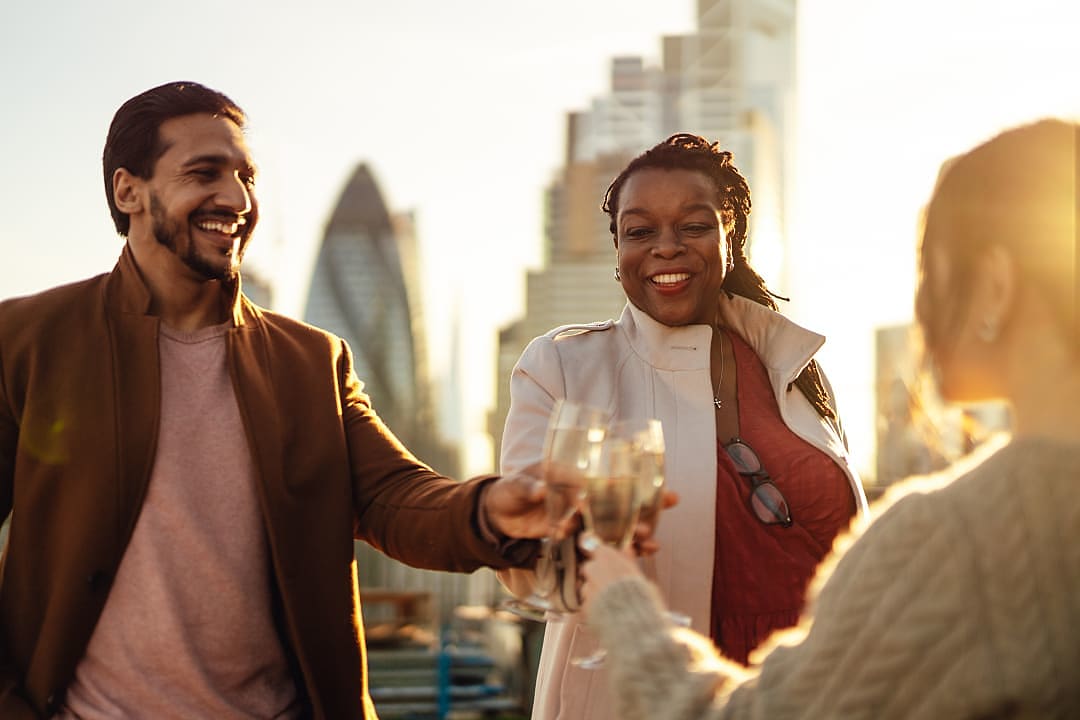 Friends enjoying time together at a rooftop hotel in London.
