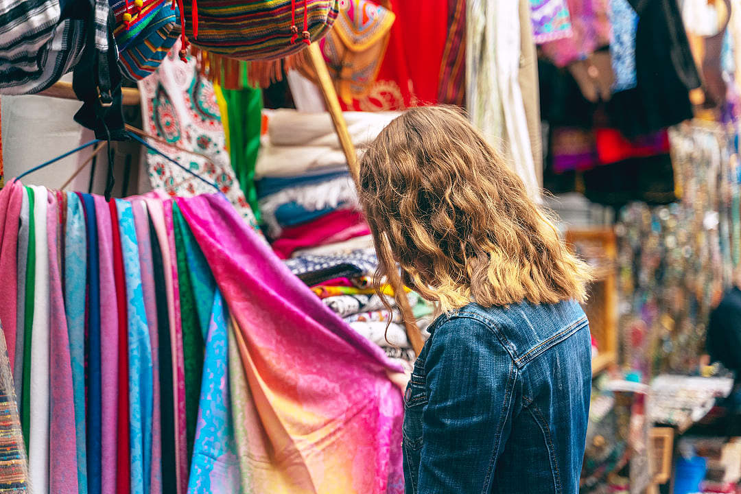 Woman looking at colorful clothes in a bazaar at Tel Aviv in Israel