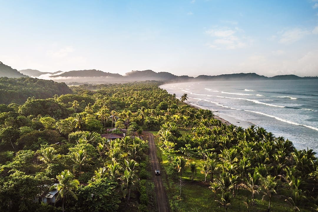 Car driving on a neighborhood road near Bejuco Beach in Guanacaste, Costa Rica