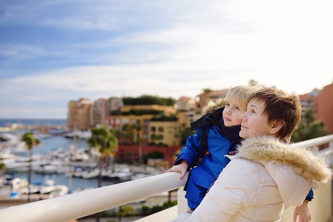 Mother and grandchild dressed for cold weather in Côte d'Azur, France