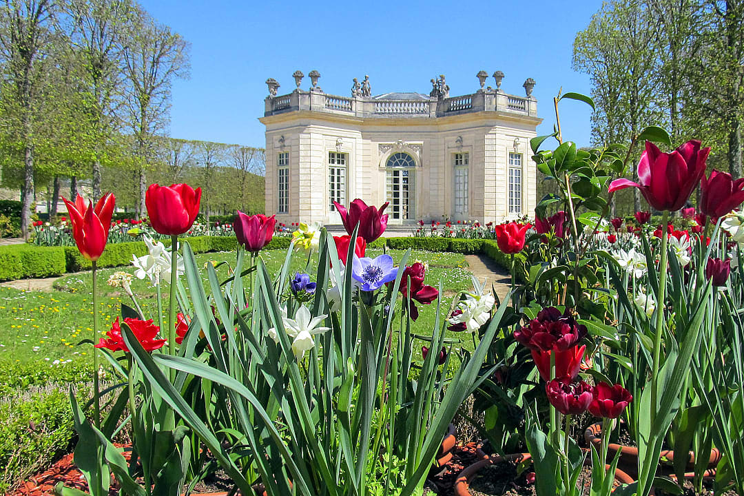 Petit Trianon estate surrounded by lush gardens at the Palace of Versailles,