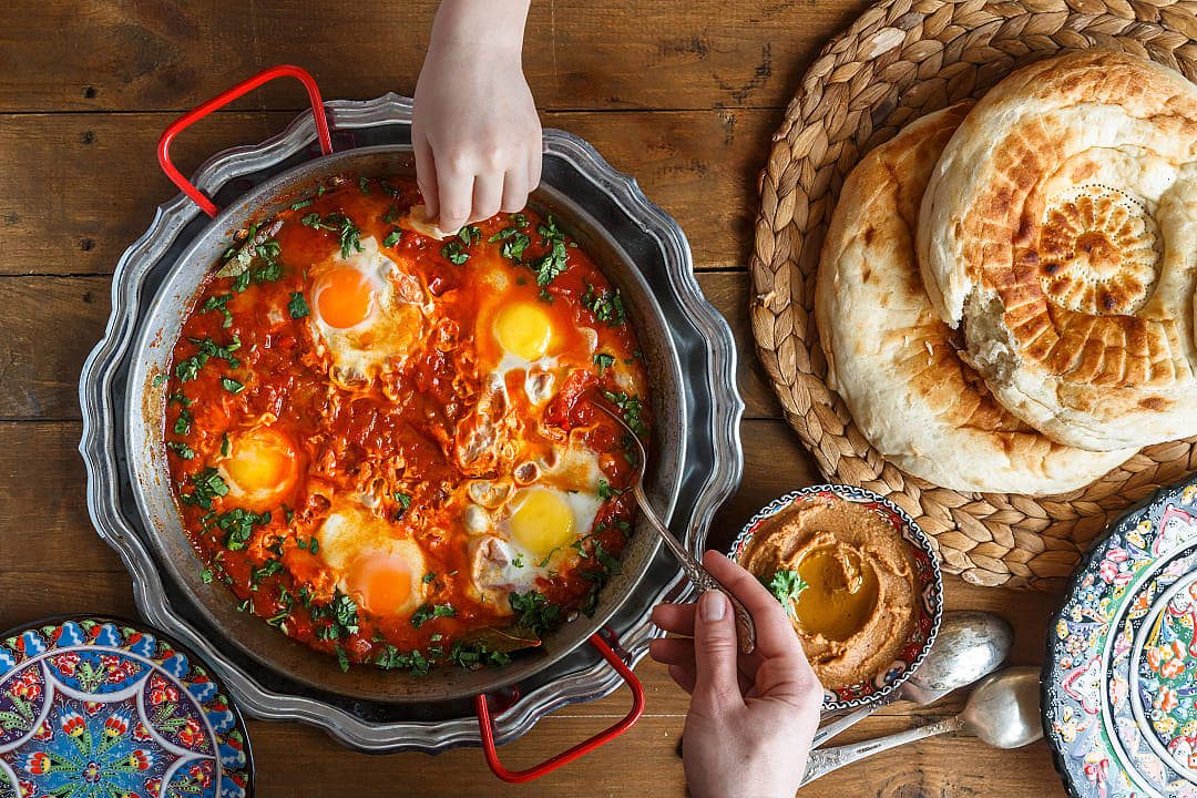 Family sharing shakshuka in Israel