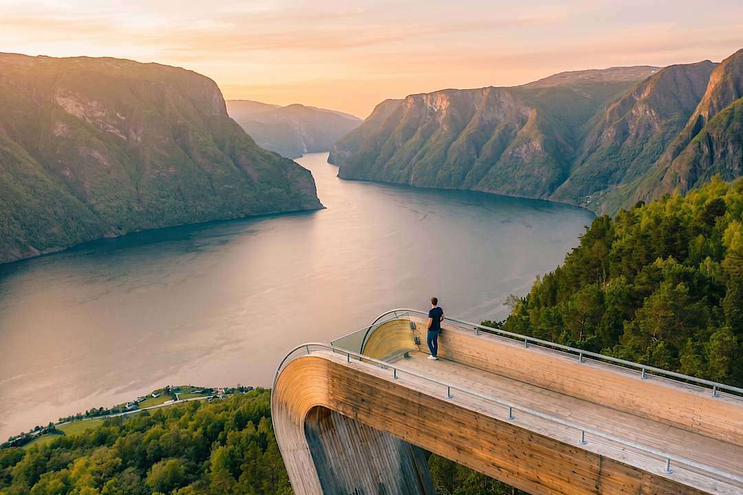 Traveler overlooking Aurlandsfjord from the Stegastein Viewpoint in western Norway
