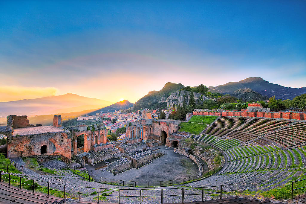 The ancient greek theater of Taormina with Etna volcano in the background