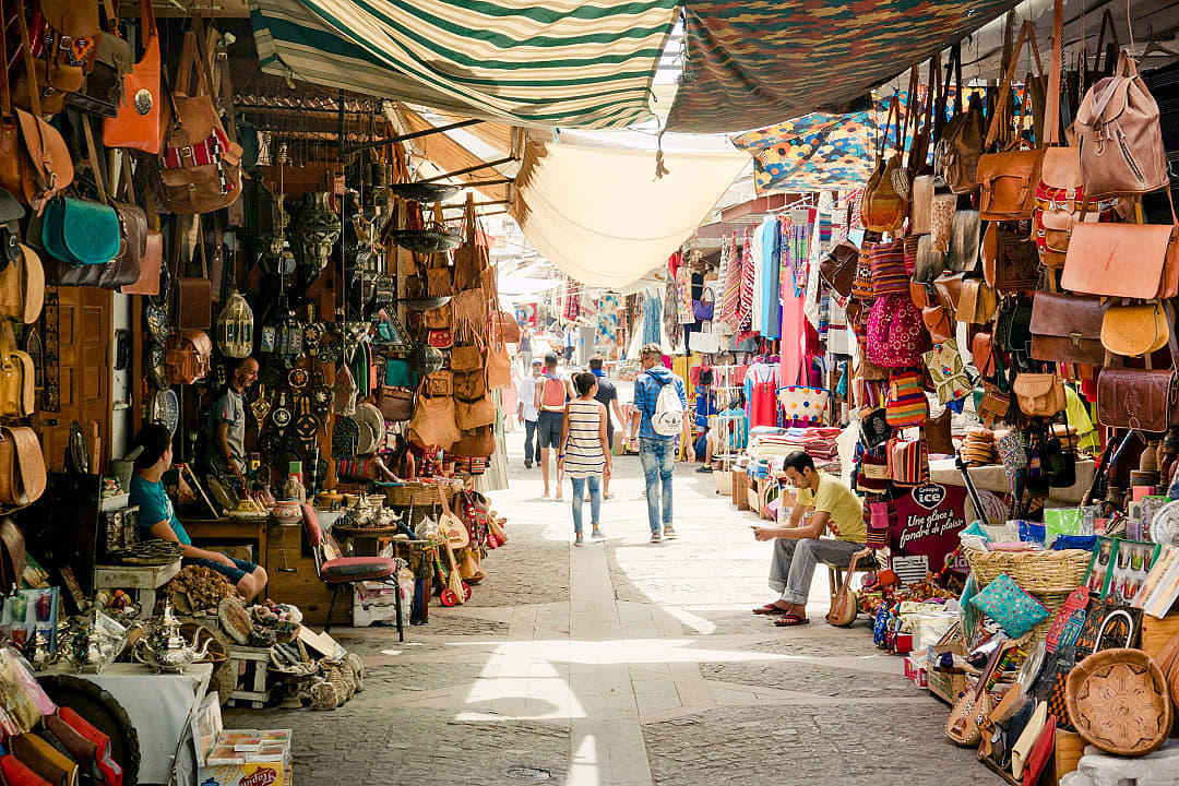 Travelers walking through a souk in Marrakech, Morocco