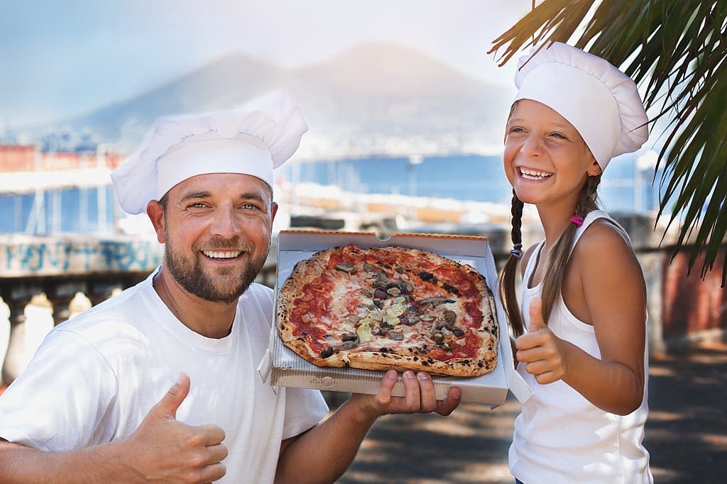 Dad and daughter with traditional Italian pizza, Naples