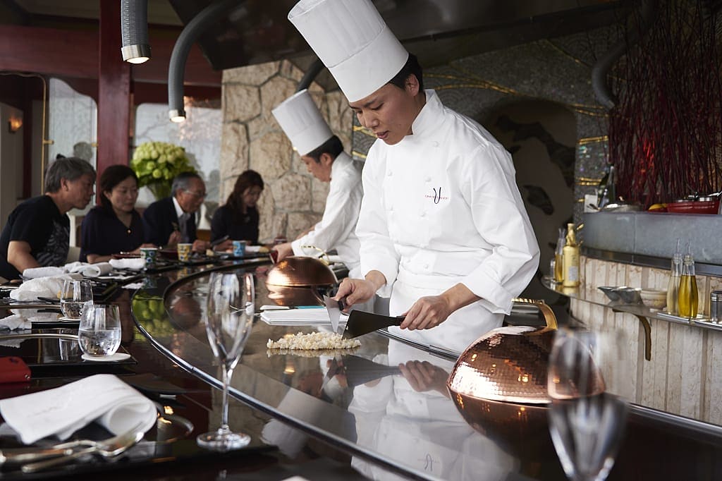 Chef preparing food at restaurant in Tokyo, Japan