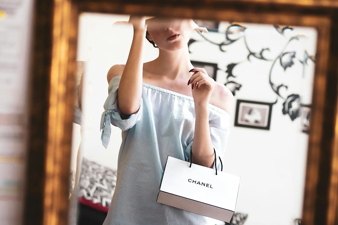 Woman enjoying a haute couture shopping experience.