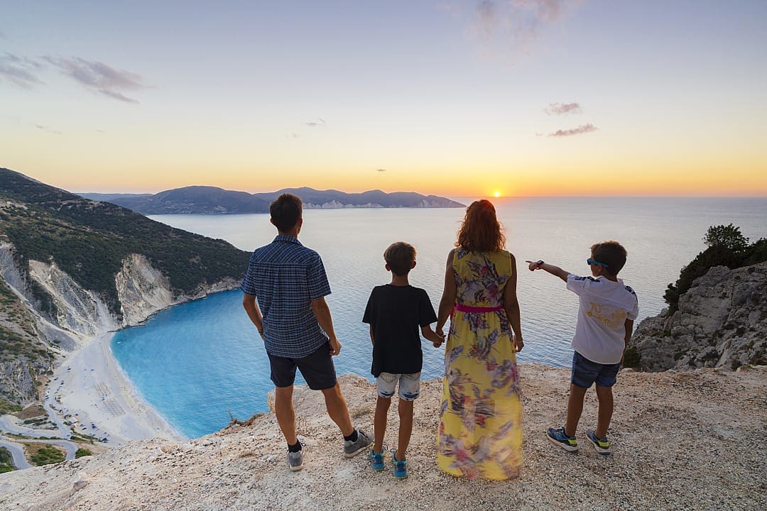 A family admires the view of Myrtos Beach on Kefalonia Island, Greece