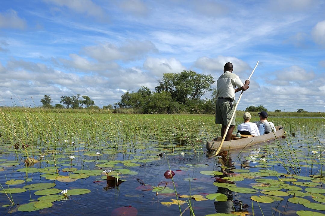 Couple on mokoro safari in the Okavango Delta, Botswana