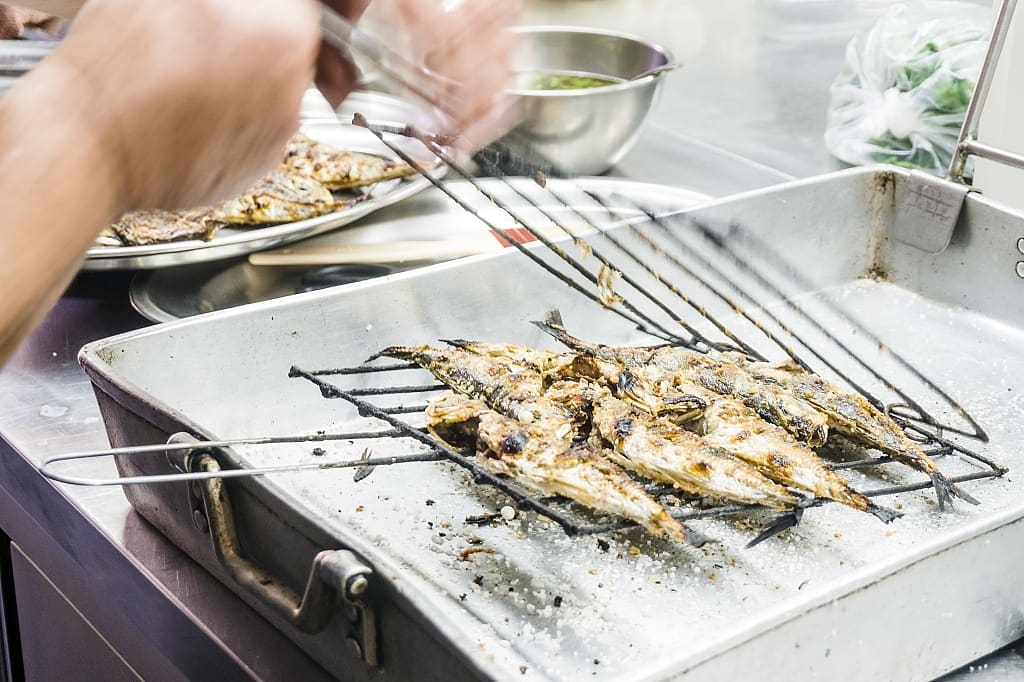 Cooking barbecued mackerels in Portugal