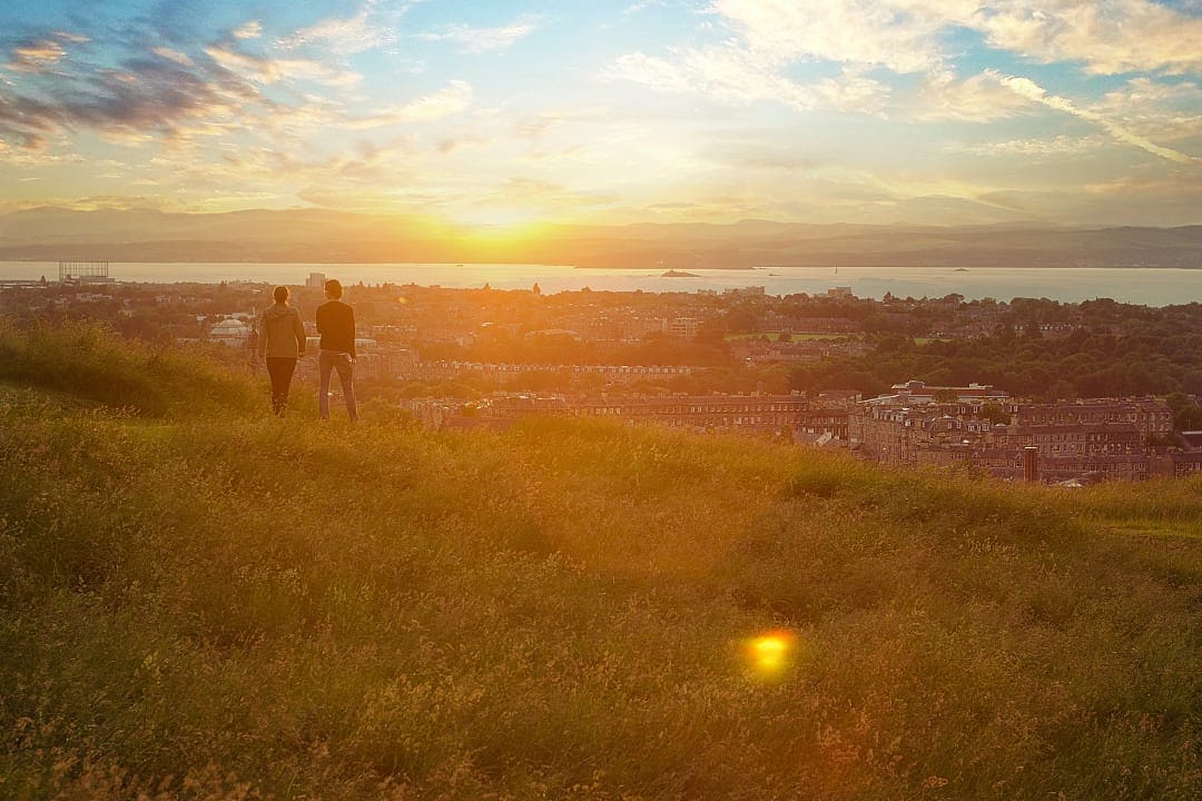 Couple enjoys view and sunset in Edinburgh, Scotland