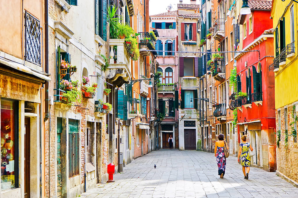 Two women walking the streets in Venice, Italy