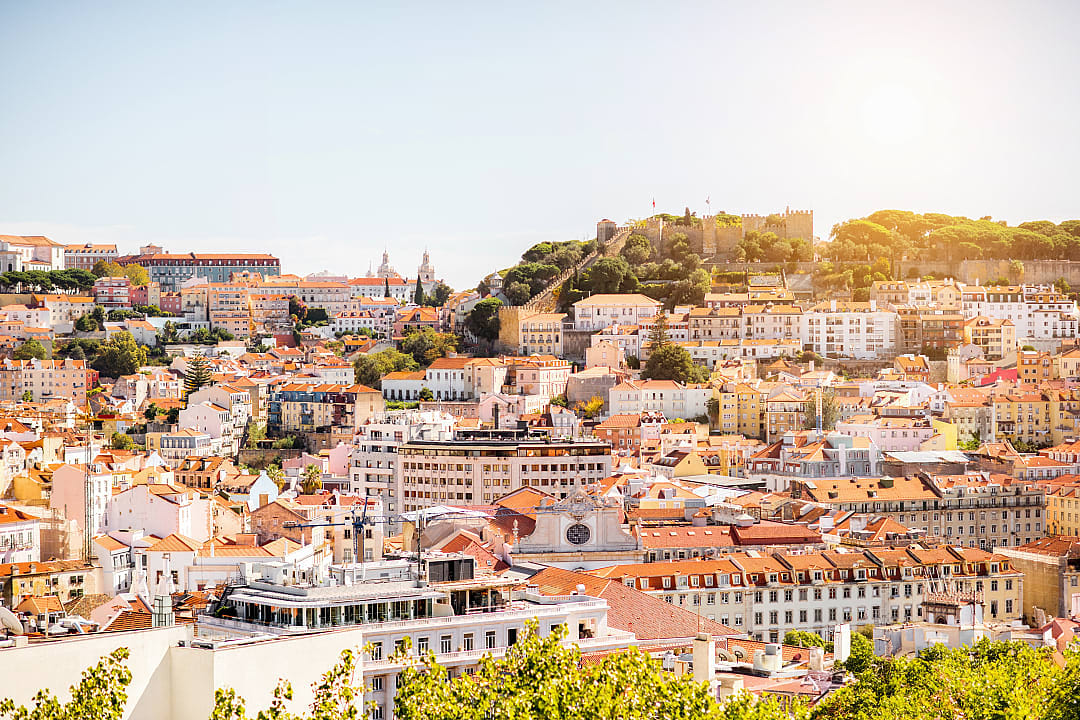 Cityscape of old town Lisbon with castle on the hill during sunny summer weather Portugal