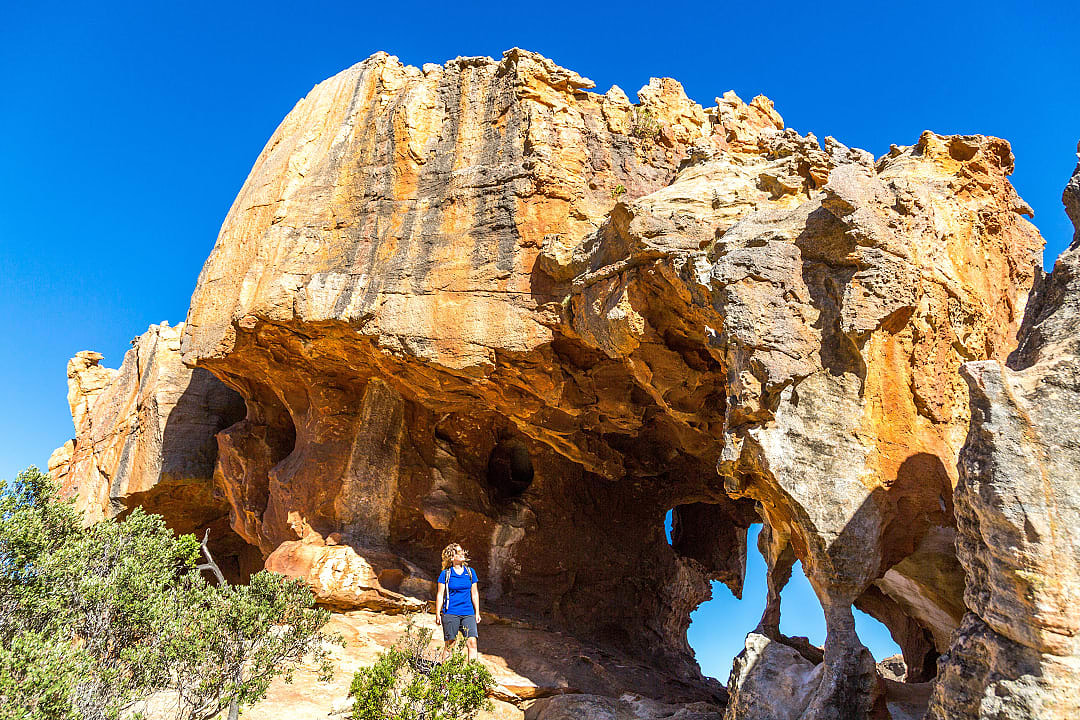 Woman exploring Stadsaal Caves in Cederberg Wilderness Area, South Africa