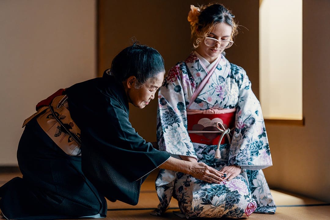 Traditional Japanese tea ceremony instruction in a tatami room.