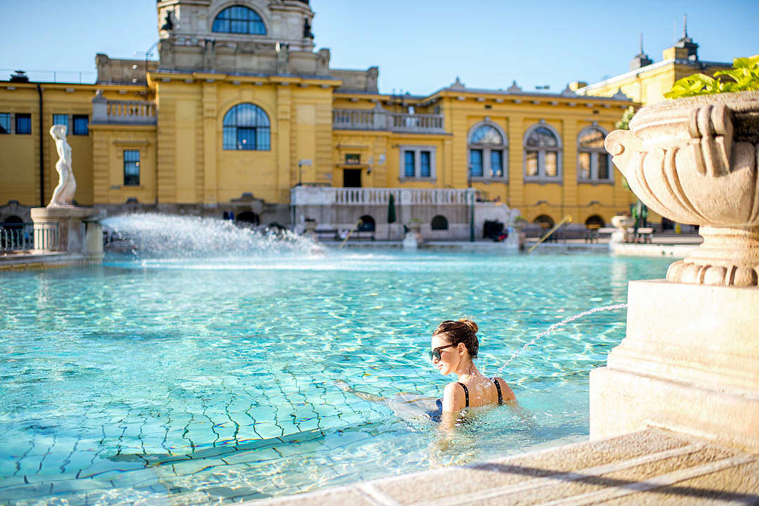 Woman relaxing in the outdoor pool at Széchenyi Thermal Bath in Budapest, Hungary